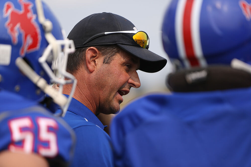Dave Largent talks with his team about some adjustments